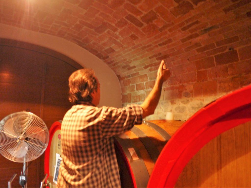 Mario Fontana with the wine barrels