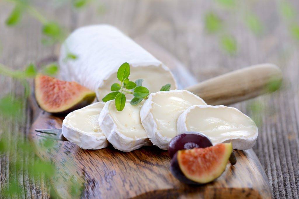 goat cheese and figs on a wooden board